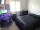 Bright bedroom with a double bed, desk, and window at 717 S 123Rd Dr, Avondale, AZ 85323