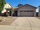 Single-story home with attached two-car garage and desert landscaping at 717 S 123Rd Dr, Avondale, AZ 85323