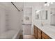 Bathroom with double vanity, tub shower combo, and access to bedroom at 826 E Bradstock Way, San Tan Valley, AZ 85140
