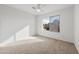 Bedroom with large window, ceiling fan, and neutral carpeting at 826 E Bradstock Way, San Tan Valley, AZ 85140