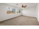 Large bedroom with two windows, a ceiling fan, and carpet at 826 E Bradstock Way, San Tan Valley, AZ 85140