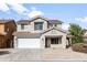 Two-story house with a white garage door and desert landscaping at 826 E Bradstock Way, San Tan Valley, AZ 85140
