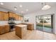 Kitchen features wood cabinets, stainless steel appliances, and an island at 826 E Bradstock Way, San Tan Valley, AZ 85140