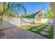 Landscaped backyard with artificial turf, shade sail, and patio at 8642 E Monterosa Ave, Scottsdale, AZ 85251