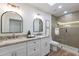 Elegant bathroom with double vanity, large mirror, and a walk-in shower at 8642 E Monterosa Ave, Scottsdale, AZ 85251