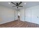 Spacious bedroom with wood floors, ceiling fan, and ample closet space at 8642 E Monterosa Ave, Scottsdale, AZ 85251