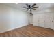 Bedroom with hardwood floors, ceiling fan, and doors to closets at 8642 E Monterosa Ave, Scottsdale, AZ 85251