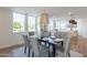 Bright dining room features a large table with seating for six and modern light fixtures at 8642 E Monterosa Ave, Scottsdale, AZ 85251
