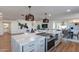 Open kitchen features a large island with seating, stainless steel appliances, and ample counter space at 8642 E Monterosa Ave, Scottsdale, AZ 85251