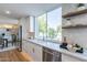 Modern kitchen with white cabinets, quartz countertops and stainless steel appliances at 8642 E Monterosa Ave, Scottsdale, AZ 85251