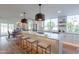 Modern kitchen with large island, white cabinets, quartz countertops and stainless steel appliances at 8642 E Monterosa Ave, Scottsdale, AZ 85251