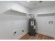 Laundry room with shelving, water heater, and tiled floor at 8642 E Monterosa Ave, Scottsdale, AZ 85251