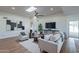 Bright living room with hardwood floors, stylish furniture, and a large flat-screen TV at 8642 E Monterosa Ave, Scottsdale, AZ 85251