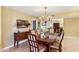 Elegant dining room with a chandelier and hardwood table at 9711 W Briarwood Cir, Sun City, AZ 85351