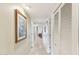 Clean hallway with light walls, tile flooring and linen closet at 9711 W Briarwood Cir, Sun City, AZ 85351