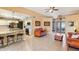 Living room with leather sofas, kitchen and entry views at 9711 W Briarwood Cir, Sun City, AZ 85351