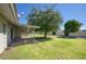 Large backyard with grassy lawn and covered patio area at 9841 N Balboa Dr, Sun City, AZ 85351