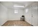 Spacious basement room with tile flooring and chair at 9841 N Balboa Dr, Sun City, AZ 85351