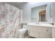 Bathroom with shower/tub combo, toilet, and vanity with storage at 9841 N Balboa Dr, Sun City, AZ 85351