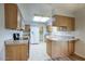 Kitchen with wood cabinets, tile flooring, and stainless steel appliances at 9841 N Balboa Dr, Sun City, AZ 85351