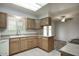 Kitchen features wood cabinets, tile floors, and a breakfast bar at 9841 N Balboa Dr, Sun City, AZ 85351