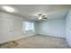 Living room featuring light walls, neutral carpeting and a window with curtains at 9841 N Balboa Dr, Sun City, AZ 85351