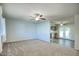 Bright living room with light walls, neutral carpeting, and ceiling fan at 9841 N Balboa Dr, Sun City, AZ 85351