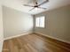 Bright bedroom with wood-look floors and a ceiling fan at 10080 E Mountain View Lake Dr # 140, Scottsdale, AZ 85258