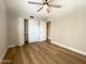 Bedroom with wood floors, ceiling fan and double door closet at 10080 E Mountain View Lake Dr # 140, Scottsdale, AZ 85258