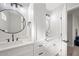 Modern bathroom with double vanity, white cabinets, and a large mirror at 1010 E Indianola Ave, Phoenix, AZ 85014