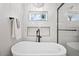 Elegant bathroom with soaking tub and window at 1010 E Indianola Ave, Phoenix, AZ 85014