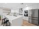 Modern kitchen with white cabinets, stainless steel appliances, and large island at 1010 E Indianola Ave, Phoenix, AZ 85014