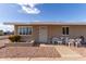 Tan single story home with small front patio and seating at 10518 W Oakmont Dr, Sun City, AZ 85351