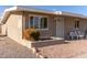 Tan single story home with small front patio and seating at 10518 W Oakmont Dr, Sun City, AZ 85351