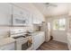 Bright kitchen features white cabinetry, appliances, and laminate flooring at 10518 W Oakmont Dr, Sun City, AZ 85351