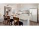 White kitchen with island and stainless steel appliances at 10518 W Oakmont Dr, Sun City, AZ 85351