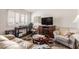 Living room with couches, fireplace, and small table at 10518 W Oakmont Dr, Sun City, AZ 85351