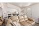 Living room with light beige couch and kitchen view at 10518 W Oakmont Dr, Sun City, AZ 85351