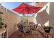 Private patio perfect for outdoor dining, featuring a red umbrella and comfortable seating at 10518 W Oakmont Dr, Sun City, AZ 85351