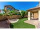 Artificial turf backyard with a covered patio and mature trees at 1059 W Caroline Ln, Tempe, AZ 85284