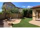 Backyard with artificial turf and a playful water feature at 1059 W Caroline Ln, Tempe, AZ 85284