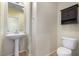 Well-appointed bathroom with pedestal sink and dark wood cabinet at 1059 W Caroline Ln, Tempe, AZ 85284