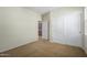 Bright bedroom with neutral walls and carpet, plus closet at 1059 W Caroline Ln, Tempe, AZ 85284