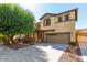 Two-story house with stone accents and a two-car garage at 1059 W Caroline Ln, Tempe, AZ 85284