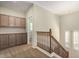 Upstairs hall with built-in cabinets and wooden staircase at 1059 W Caroline Ln, Tempe, AZ 85284