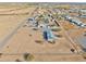 Aerial view of a home with a pool, showcasing a sizable lot and desert surroundings at 10991 W Hilltop Dr, Casa Grande, AZ 85193