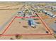 Aerial view of a home with a pool, showcasing a sizable lot and desert surroundings at 10991 W Hilltop Dr, Casa Grande, AZ 85193