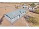 Rear view of a manufactured home showcasing a patio and gravel landscaping at 10991 W Hilltop Dr, Casa Grande, AZ 85193