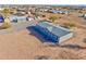 Aerial view showcasing a manufactured home, detached shed, and ample land at 10991 W Hilltop Dr, Casa Grande, AZ 85193