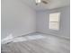 Simple bedroom with gray walls, vinyl flooring, and a ceiling fan at 10991 W Hilltop Dr, Casa Grande, AZ 85193